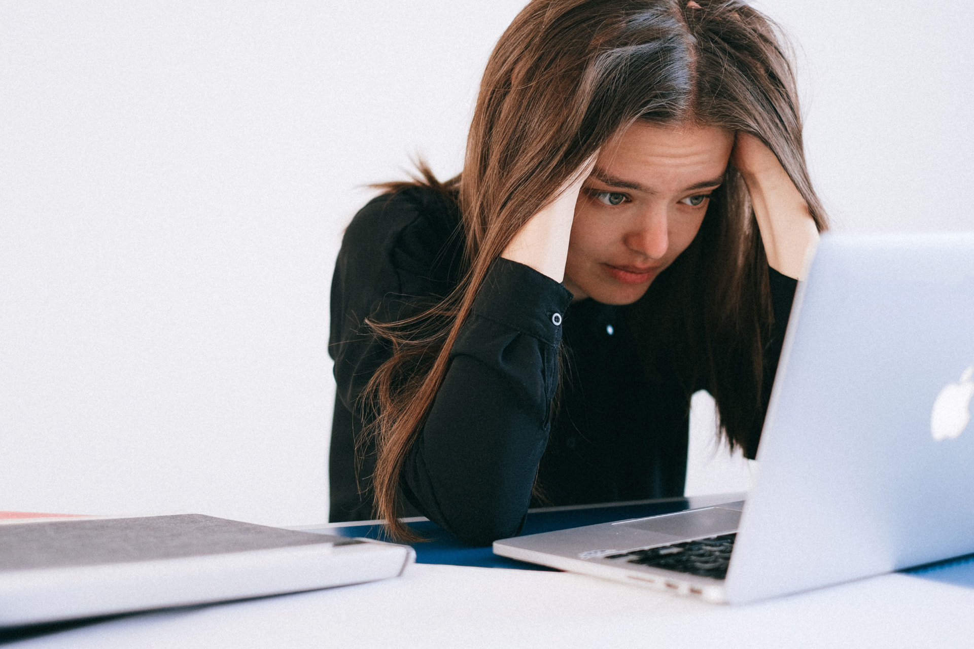 A marketer stressed in front of a laptop